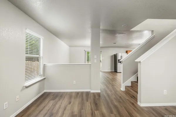 a view of entryway and hall with wooden floor