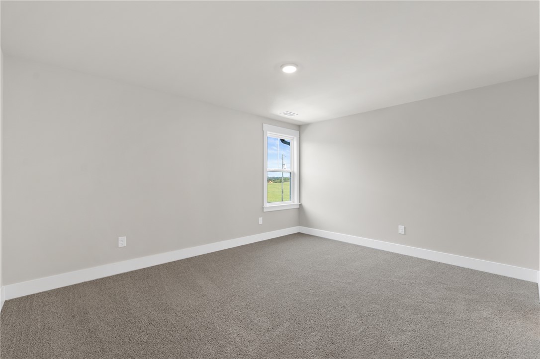167 Tiger Lily Drive Anderson, SC 29621 - Photo 22 of 34 A well-lit, open room with plush carpeting and a serene view of the outdoors.