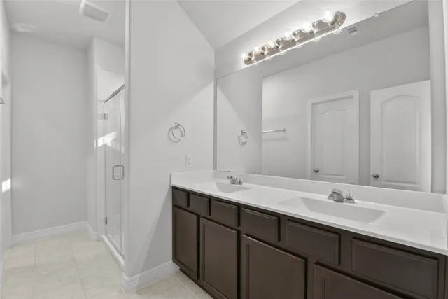 a bathroom with a double vanity sink and a mirror