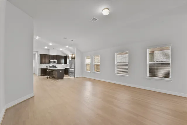 a view of a kitchen with a sink and a large window