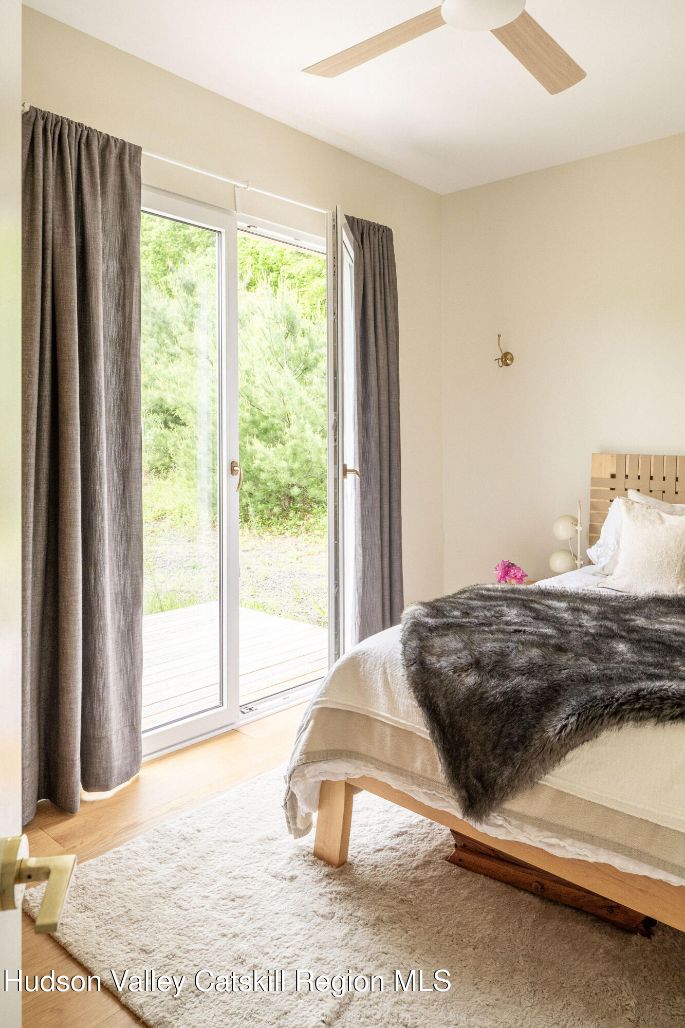 129 Krum Road Kerhonkson, NY 12446 - Photo 13 of 42 a bedroom with a bed and a large window