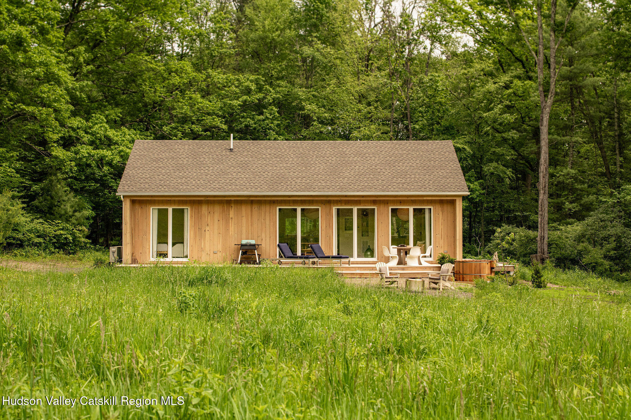 129 Krum Road Kerhonkson, NY 12446 - Photo 25 of 42 a front view of a house with a yard table and chairs