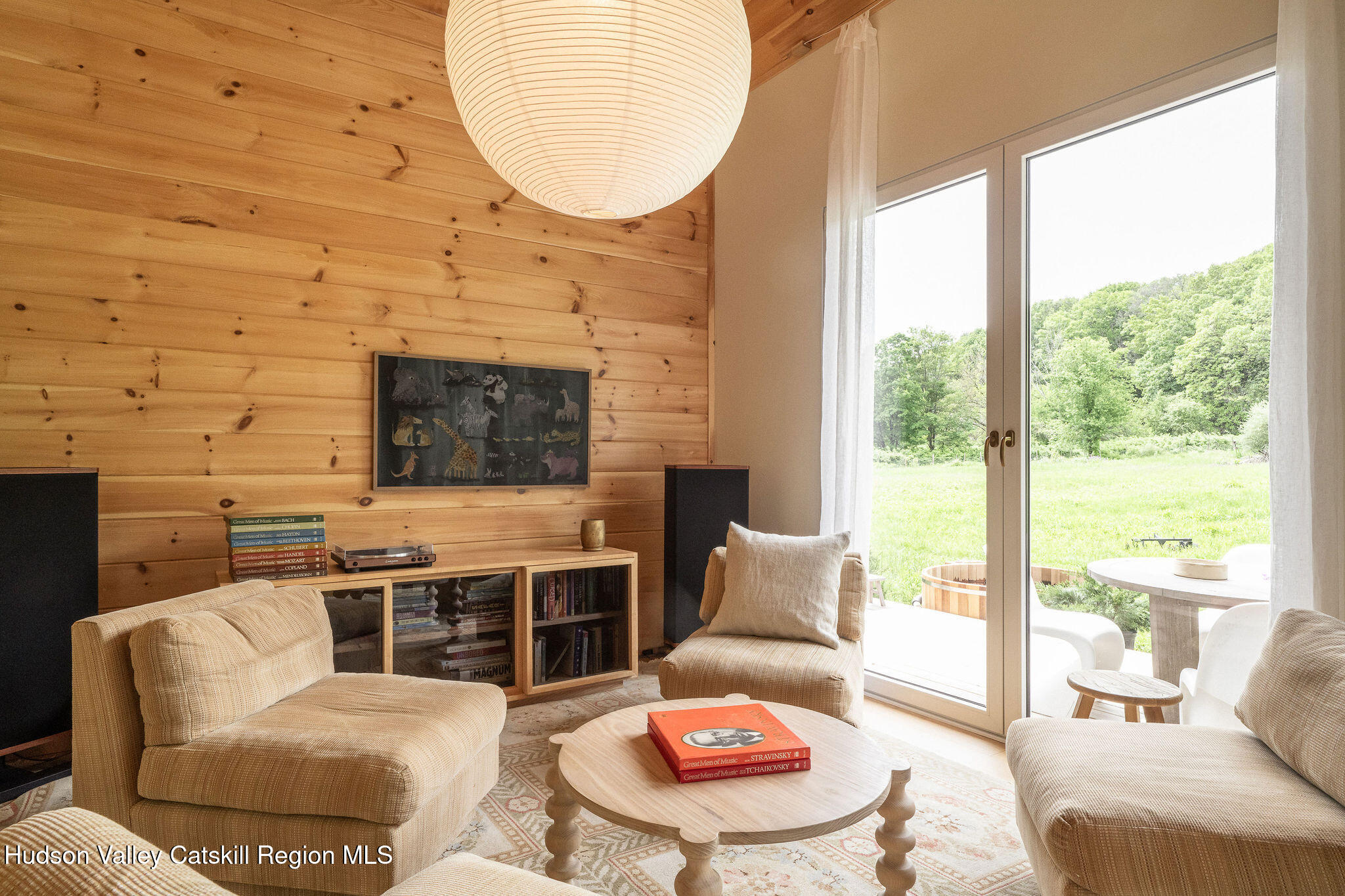 129 Krum Road Kerhonkson, NY 12446 - Photo 6 of 42 a living room with furniture a fireplace and a floor to ceiling window