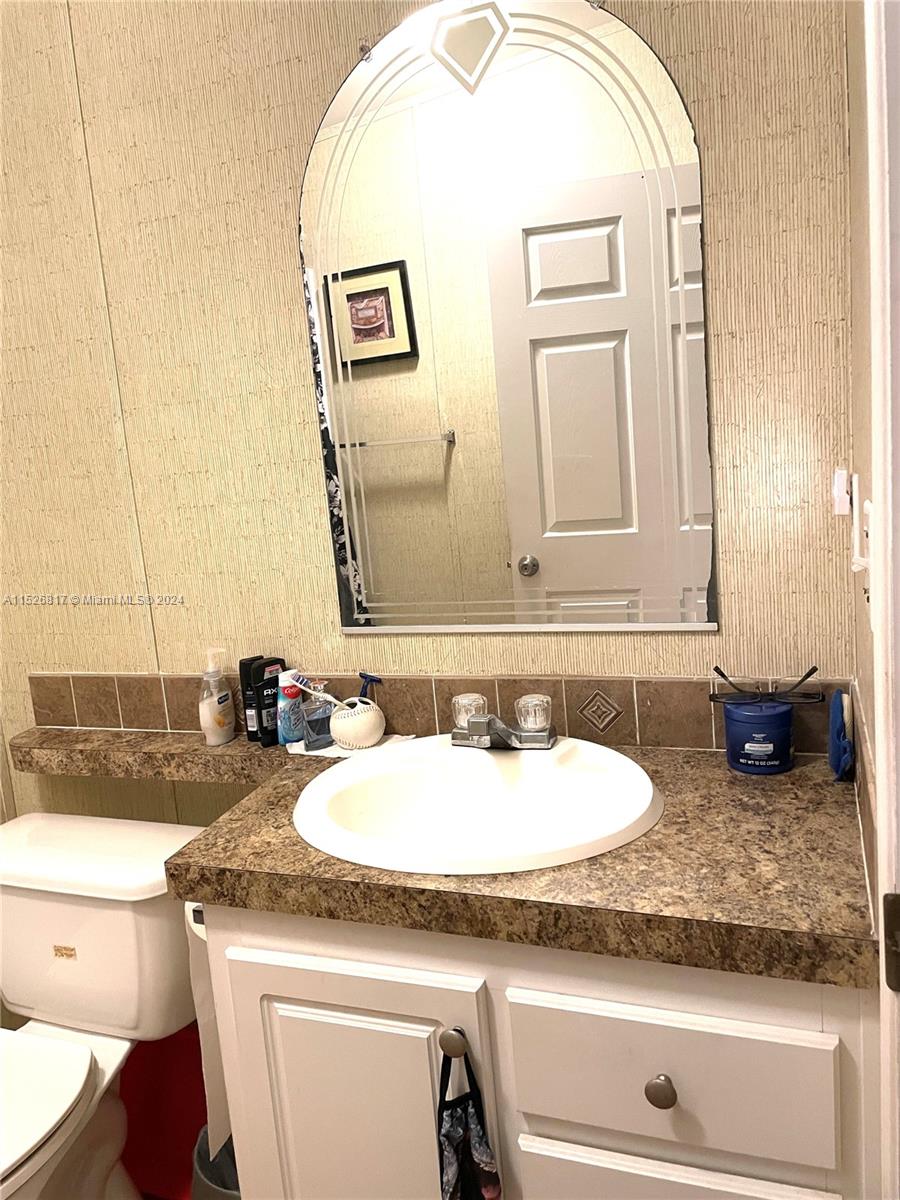 23016 Watergate Circle Boca Raton, FL 33428 - Photo 14 of 25 a bathroom with a granite countertop sink and a mirror