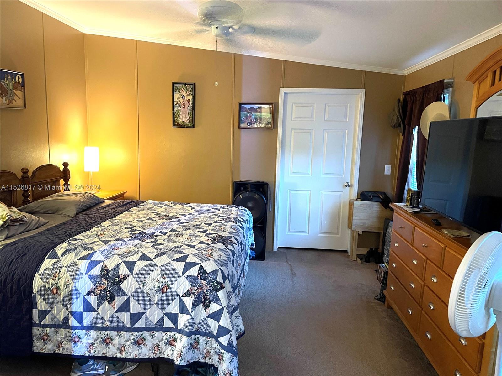 23016 Watergate Circle Boca Raton, FL 33428 - Photo 16 of 25 a bedroom with a bed and a flat tv screen