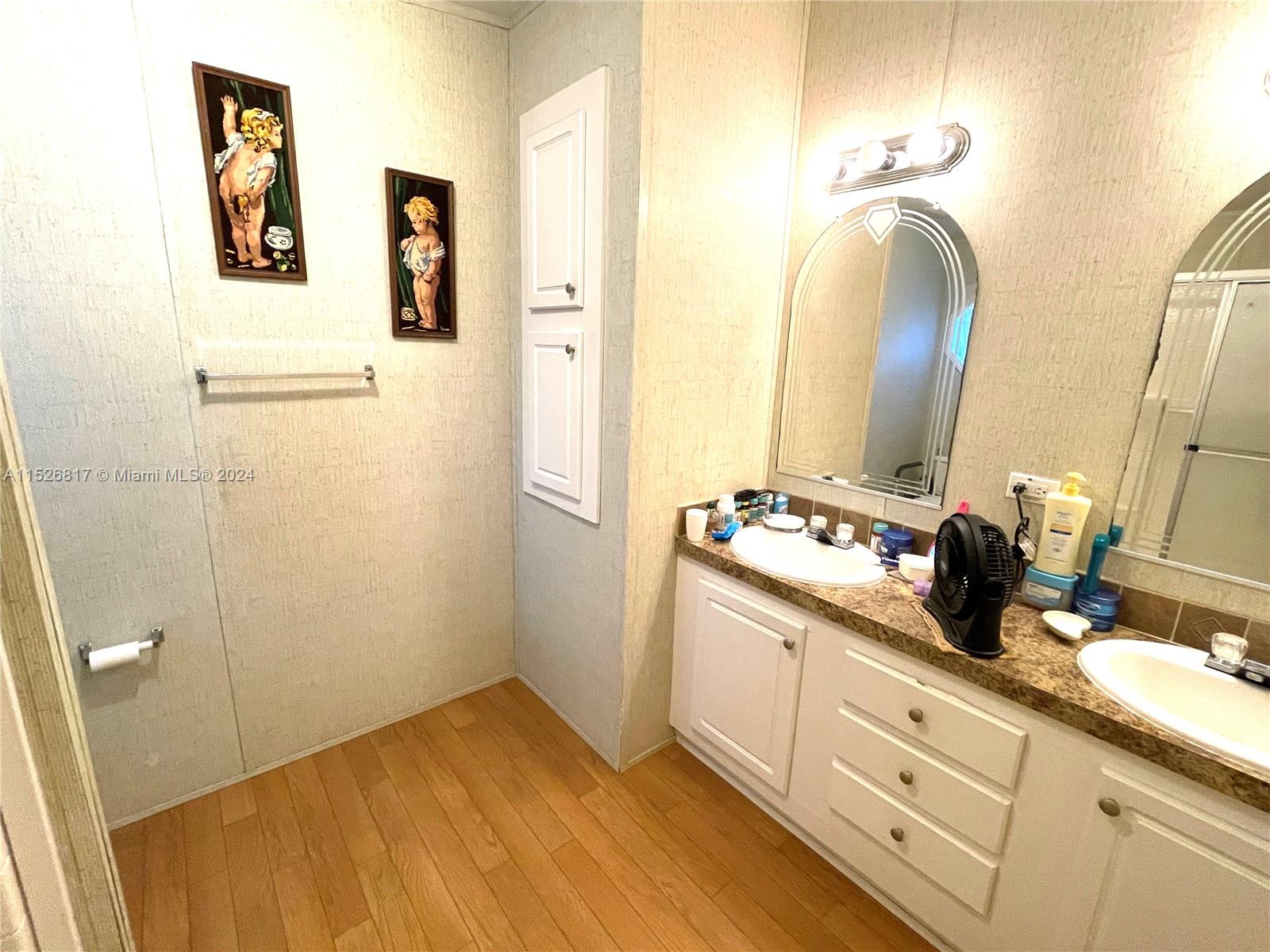 23016 Watergate Circle Boca Raton, FL 33428 - Photo 18 of 25 a bathroom with a double vanity sink and a mirror