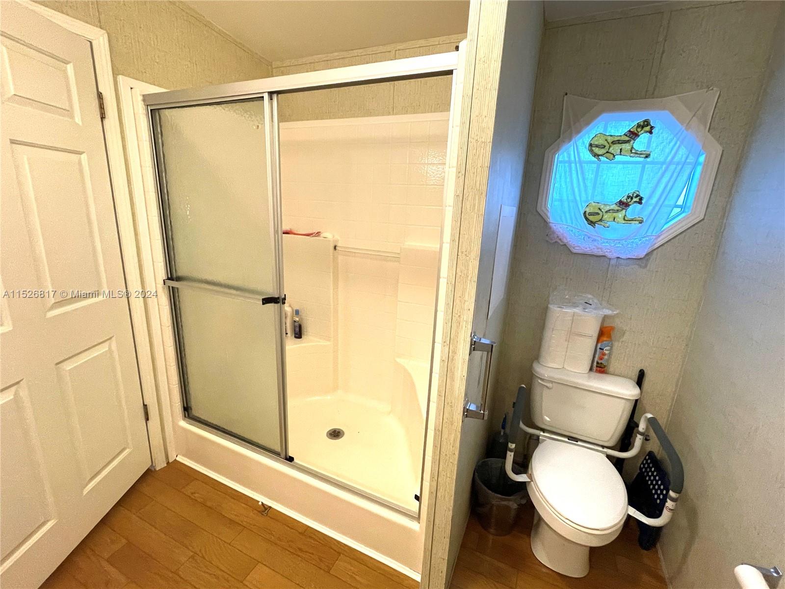 23016 Watergate Circle Boca Raton, FL 33428 - Photo 19 of 25 a bathroom with a toilet and a shower curtain