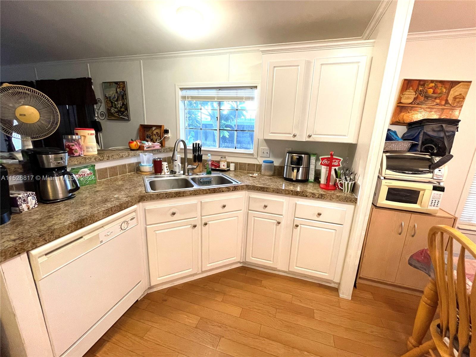 23016 Watergate Circle Boca Raton, FL 33428 - Photo 23 of 25 a kitchen with granite countertop cabinets stainless steel appliances a sink and a window