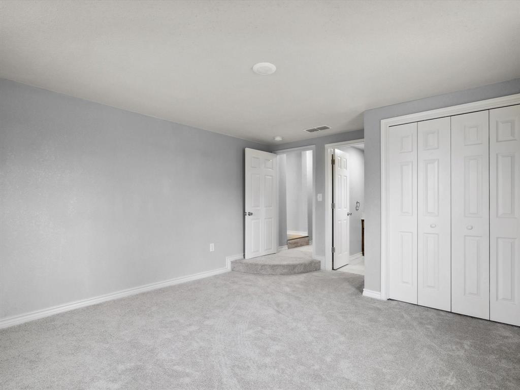 107 East Riley Street Bowie, TX 76230 - Photo 24 of 32 Unfurnished bedroom with baseboards, carpet flooring, visible vents, and a closet