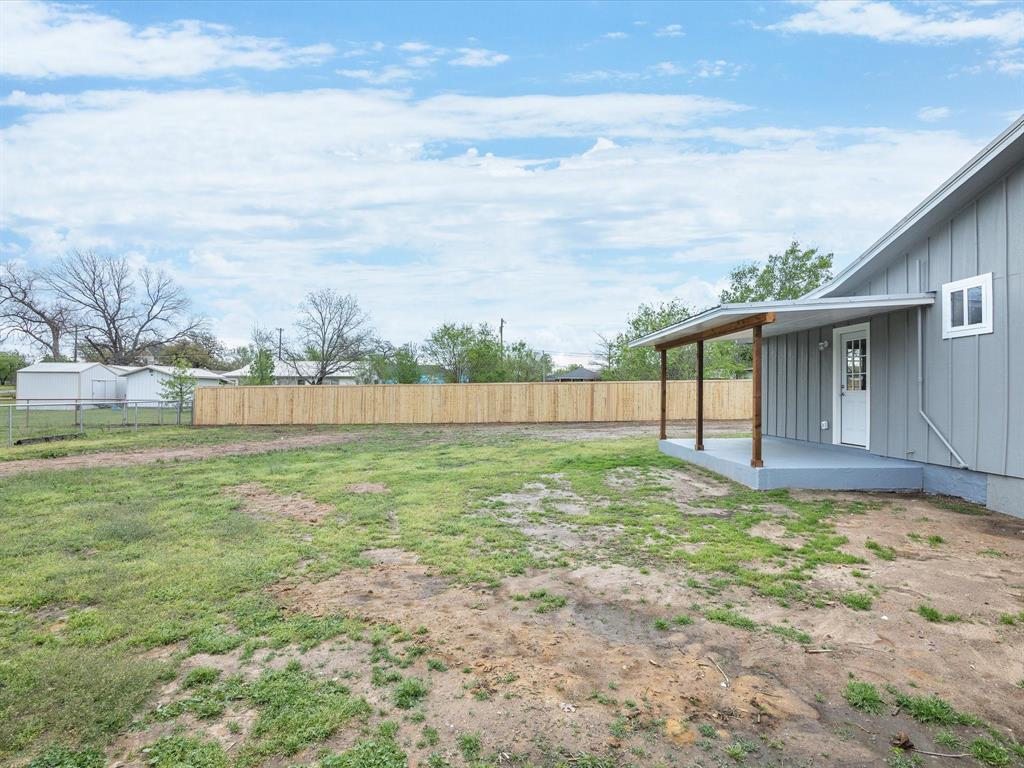 107 East Riley Street Bowie, TX 76230 - Photo 32 of 32 View of yard featuring a fenced backyard and a patio area