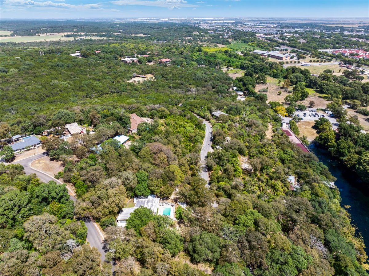 207 Rogers Ridge Street San Marcos, TX 78666 - Photo 33 of 35 A beautiful wooded canopy wraps around private homes nestled in a peaceful neighborhood setting.