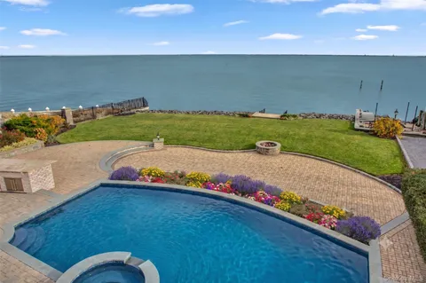 swimming pool view with a garden