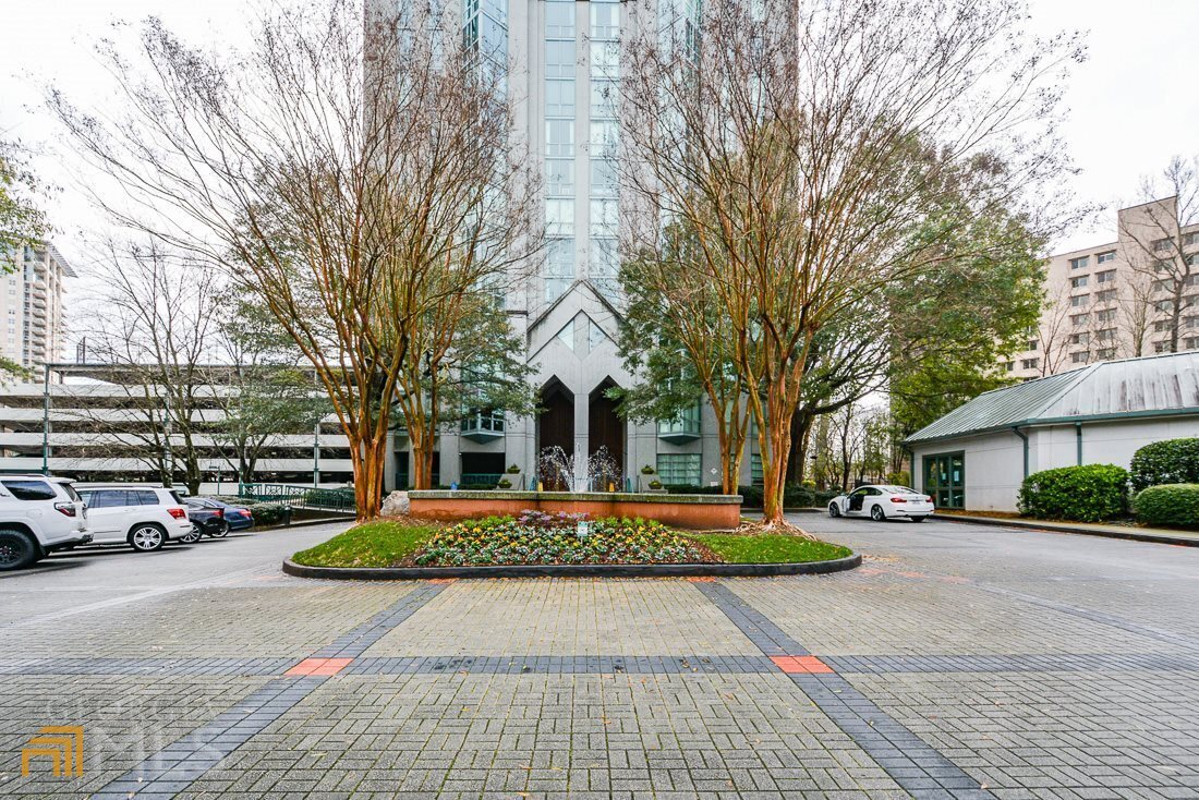 2870 Pharr Ct S Northwest, Unit 205 Atlanta, GA 30305 - Photo 1 of 1 a front view of a building with trees and cars parked