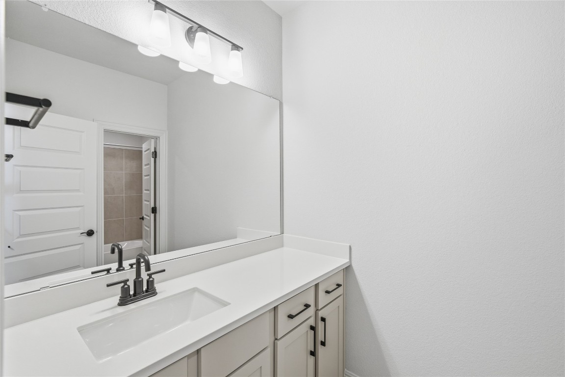 933 Sunny Ridge Drive Leander, TX 78641 - Photo 11 of 16 a bathroom with a sink and a mirror