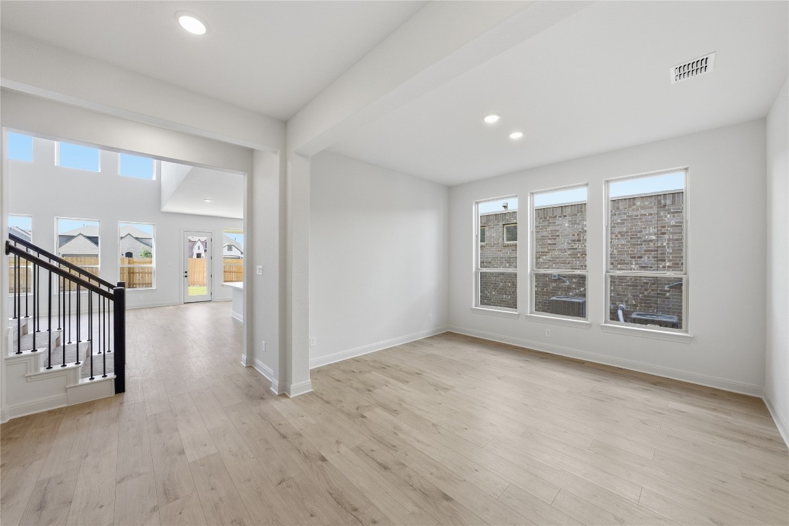 933 Sunny Ridge Drive Leander, TX 78641 - Photo 2 of 16 a view of an empty room with wooden floor and a window