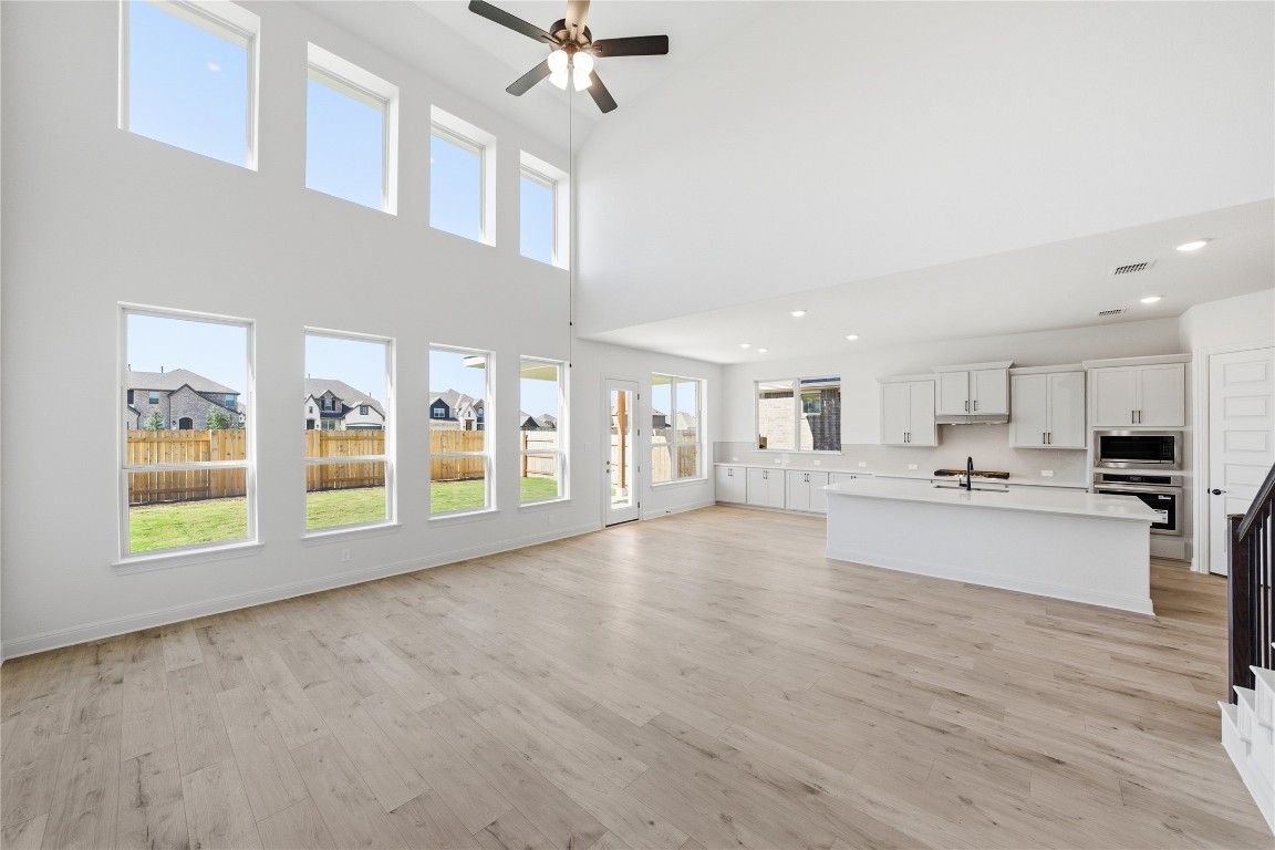 933 Sunny Ridge Drive Leander, TX 78641 - Photo 6 of 16 a view of an empty room with kitchen and window