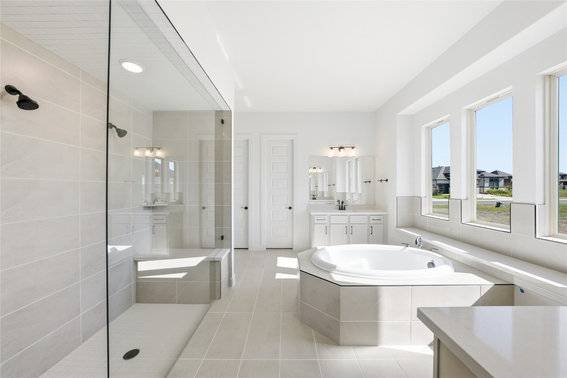 933 Sunny Ridge Drive Leander, TX 78641 - Photo 8 of 16 a bathroom with a tub a toilet a sink and shower