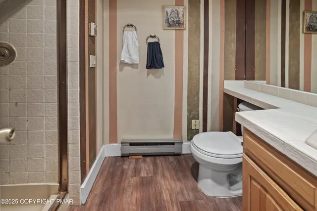 a bathroom with a toilet and a shower