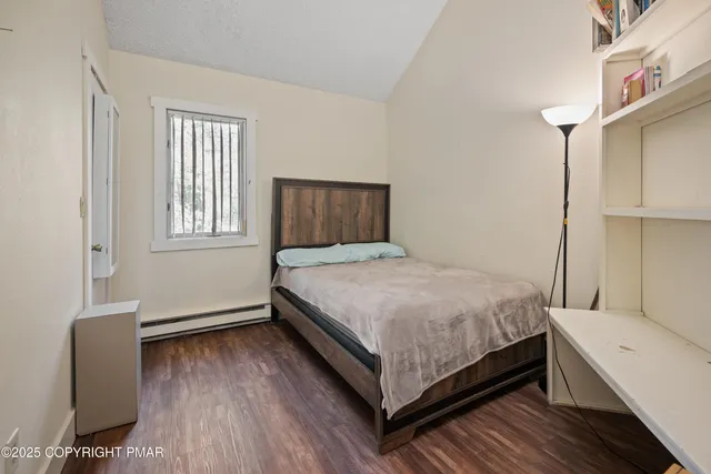 a bedroom with a bed and a chair