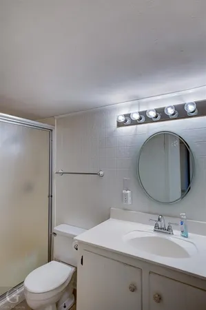 a bathroom with a sink toilet and mirror
