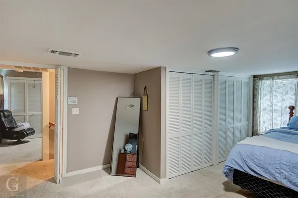 a bedroom with a bed and a view of bathroom