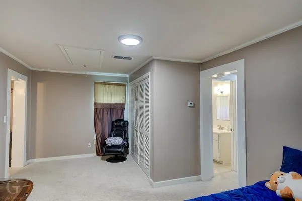 a utility room with closet and mirror