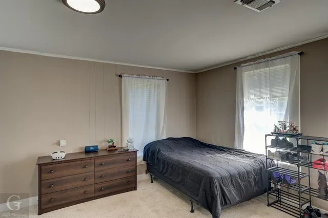 a bedroom with a bed and window