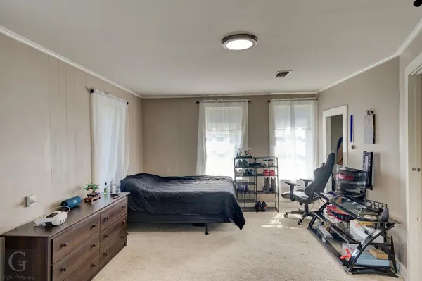 a bedroom with furniture and a window
