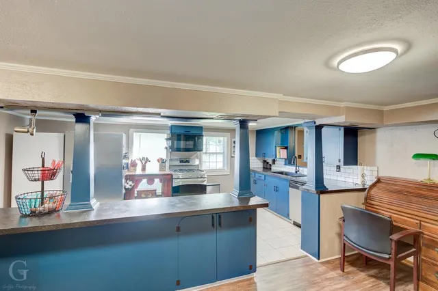 a living room with stainless steel appliances kitchen island granite countertop furniture and a kitchen view
