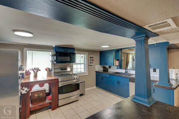 a kitchen with stainless steel appliances granite countertop a stove and a sink