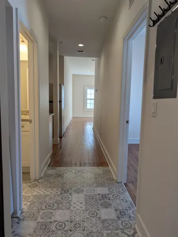 a bathroom with a granite countertop toilet sink and mirror