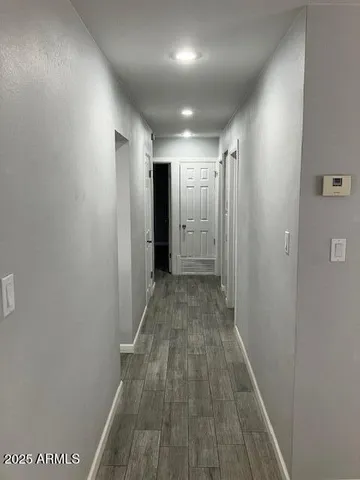 a view of hallway with wooden floor