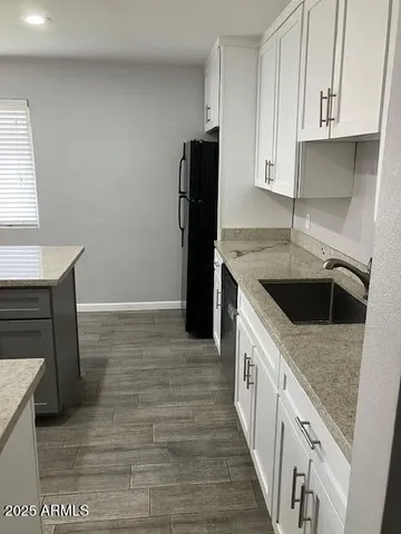 a kitchen with a sink stove and cabinets