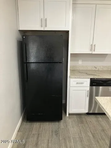 a kitchen with a refrigerator and a stove