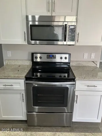 a stove top oven sitting inside of a kitchen