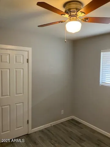 a view of a room with wooden floor and white walls