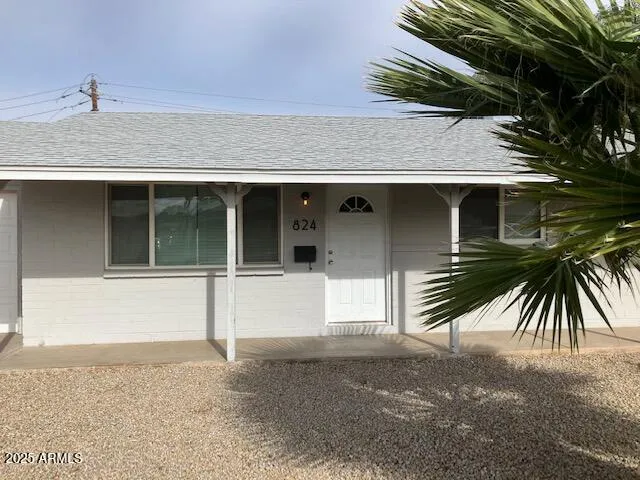 a view of a house with a backyard