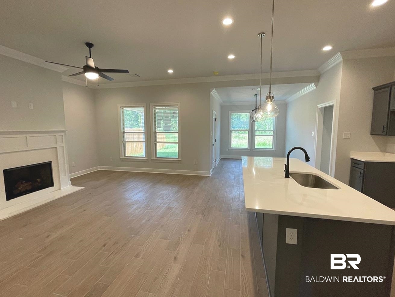 1424 Fenton Circle Foley, AL 36535 - Photo 3 of 20 Kitchen featuring ceiling fan, pendant lighting, ornamental molding, light hardwood / wood-style floors, and sink