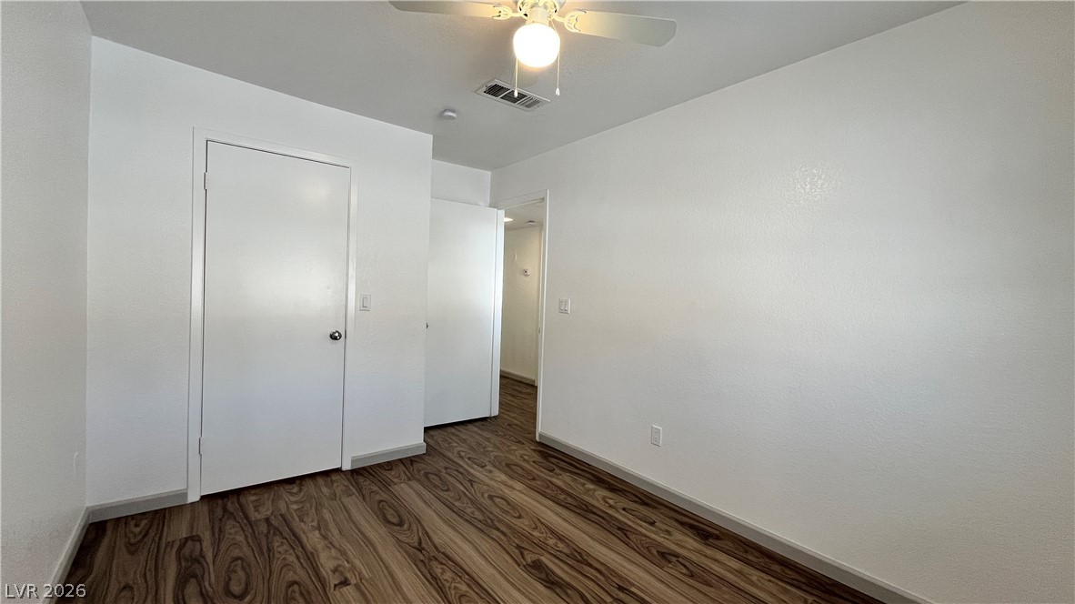 6750 Del Rey Avenue, Unit 123 Las Vegas, NV 89146 - Photo 17 of 21 Hardwood-style flooring extends across this well-lit room, featuring a cooling ceiling fan and convenient closet access.