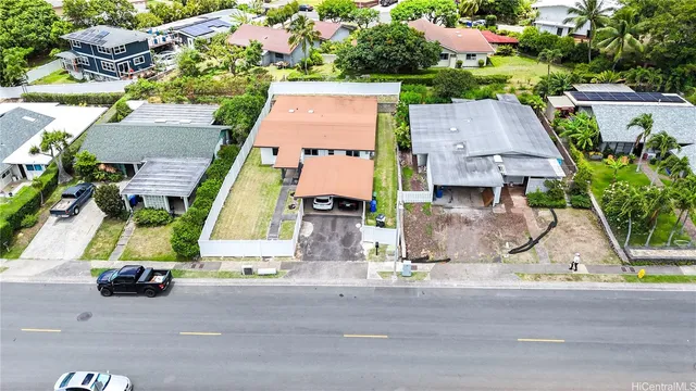 an aerial view of multiple houses with a street