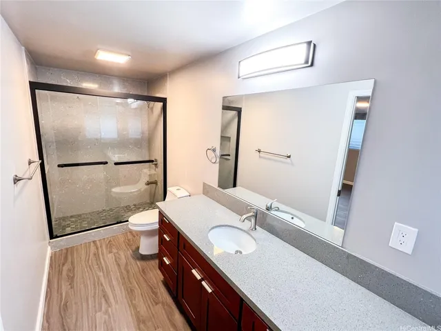 a bathroom with a sink a toilet and shower