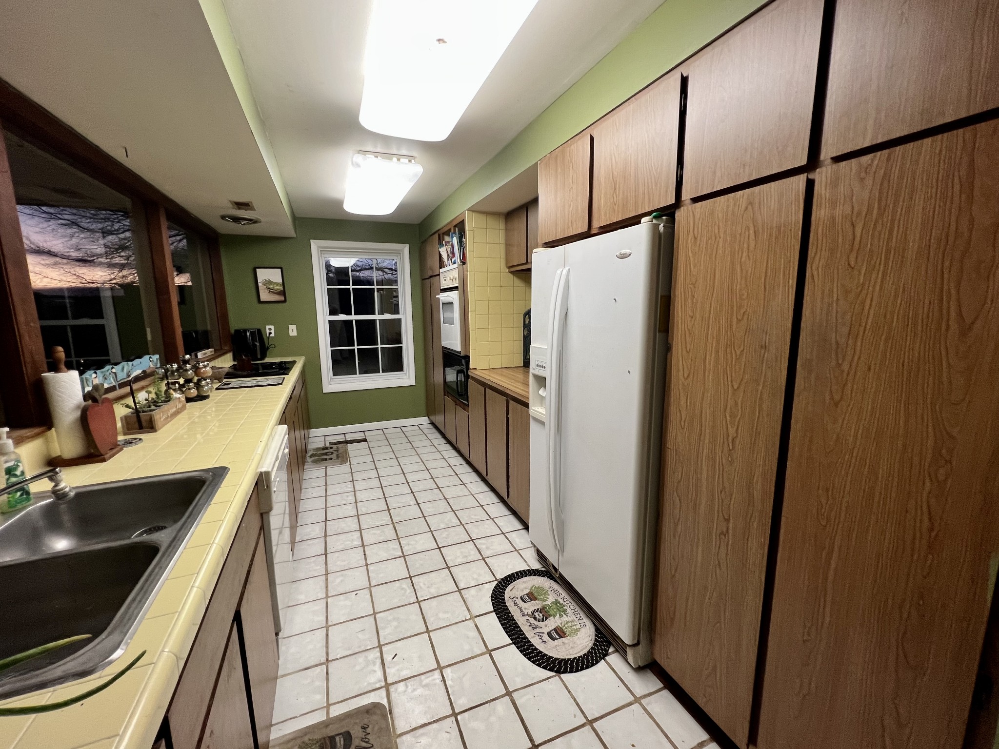 1097 Kennedy Road Manchester, TN 37355 - Photo 13 of 20 a view of a refrigerator a sink and dishwasher with wooden floor