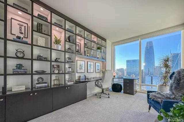 a living room with furniture and floor to ceiling windows