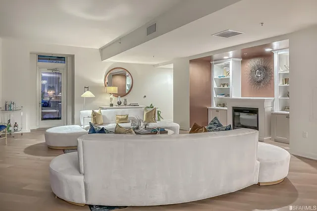 a living room with fireplace furniture and a wooden floor