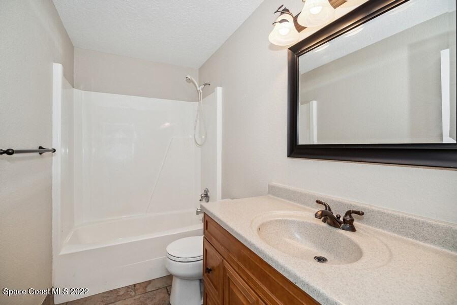 1840 Britt Road Cocoa, FL 32926 - Photo 11 of 17 a bathroom with a sink toilet mirror and shower