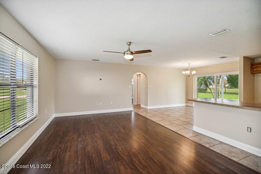 1840 Britt Road Cocoa, FL 32926 - Photo 3 of 17 an empty room with wooden floor fan and windows