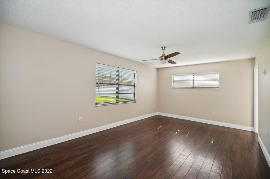 1840 Britt Road Cocoa, FL 32926 - Photo 6 of 17 an empty room with wooden floor and windows