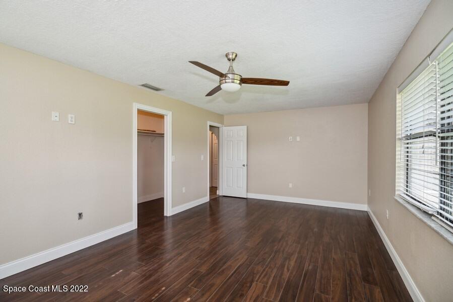 1840 Britt Road Cocoa, FL 32926 - Photo 7 of 17 wooden floor in an empty room with a window