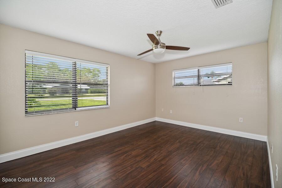 1840 Britt Road Cocoa, FL 32926 - Photo 9 of 17 a view of an empty room with wooden floor and a window