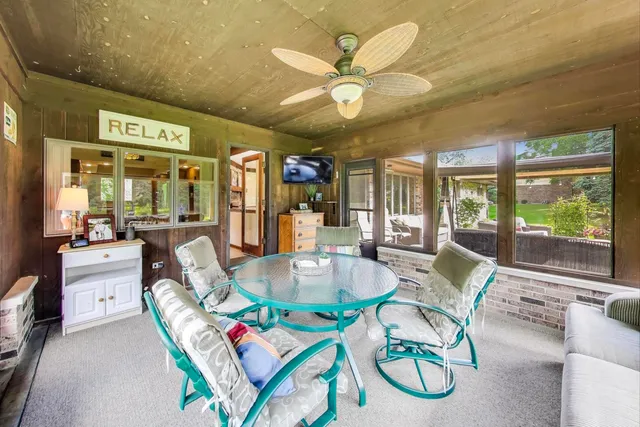 a living room with furniture a chandelier and a large window